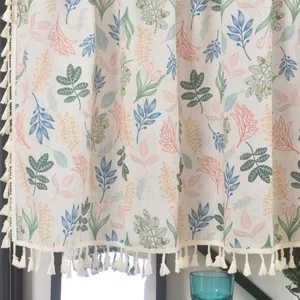 Detail of linen curtain featuring floral tulip prints and delicate fringe tassels decoration