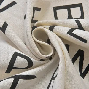 Macro shot showing the thick canvas fabric texture and black letter prints on curtain