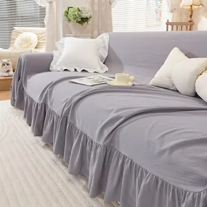 Close-up of elegant ruffled hem on a minimalist lilac linen textured sofa cover