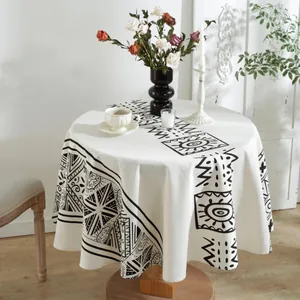Round bohemian tablecloth with black geometric patterns on cream heavy linen fabric