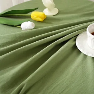 Close-up of olive green cotton tablecloth with natural texture and soft drape