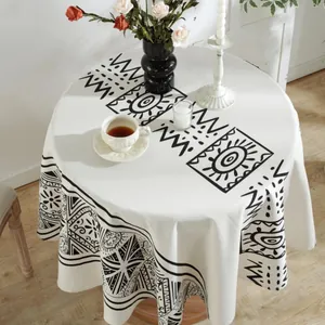 Round bohemian cotton linen tablecloth with black Moroccan geometric patterns on ivory fabric