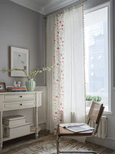 Close-up of floral embroidery and beige tassel trim on semi-blackout cotton linen curtains