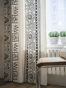 Close-up of bohemian linen curtain with black geometric tribal patterns and thick texture