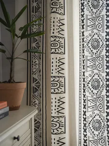 Detailed texture of cotton linen curtain with black bohemian geometric patterns