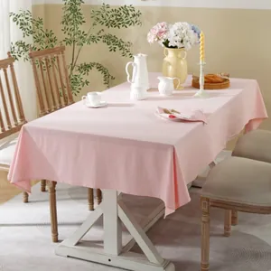 Detail of pink cotton rectangle tablecloth with natural texture and soft drape