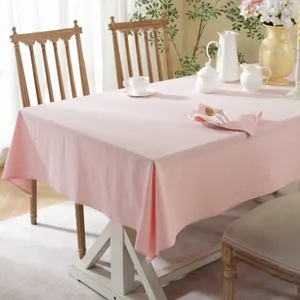 Close-up of pink cotton fabric texture on wooden table with elegant tea set setting