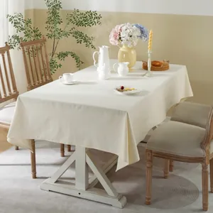 Minimalist beige rectangular linen tablecloth on a wooden table for home decor