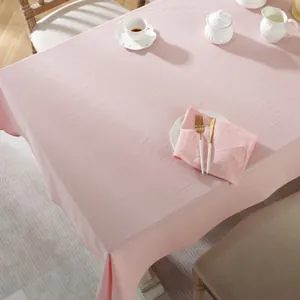 Detail showing high-quality pink cotton fabric texture and soft drape on a dining table