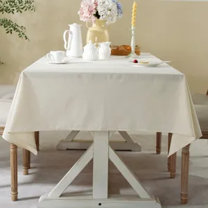 Thick rectangular cream linen tablecloth on wooden table with elegant tea set