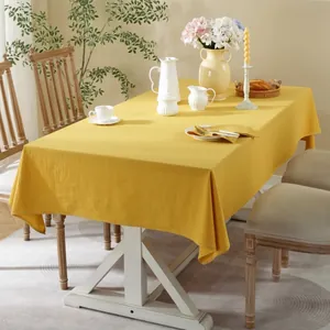 Minimalist solid yellow cotton linen rectangular tablecloth with soft draped texture