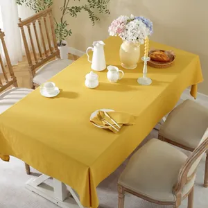 Detail of bright yellow cotton tablecloth with natural wrinkled texture and elegant drape