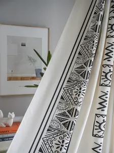 Detail of cotton linen curtain fabric featuring black bohemian geometric patterns