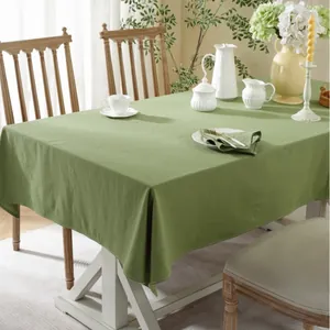 Close-up of olive green cotton tablecloth with natural texture and double-stitched edges