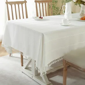 White minimalist rectangular tablecloth with textured jacquard stripes and tassel fringe