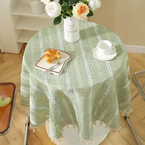 Round green tablecloth with white woven stripes and decorative tassels for dining room