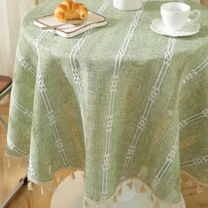 Green jacquard round tablecloth with white stripes and elegant tassel fringe detail