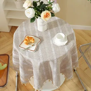 Detail of round jacquard tablecloth with bohemian woven stripes and elegant tassel fringe