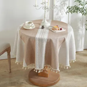 Close-up of jacquard round tablecloth featuring woven textures and elegant tassel fringe