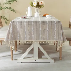 Close-up of modern geometric stripe jacquard tablecloth with creamy white tassel edge