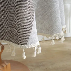 Close-up of jacquard round tablecloth with geometric patterns and handmade tassel edges