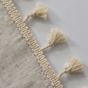Detail shot of minimalist linen door curtain fabric texture with handwoven tassel trim