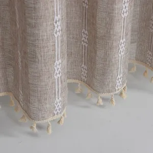 Detail of Nordic hollow jacquard curtain with white embroidery and bohemian tassels
