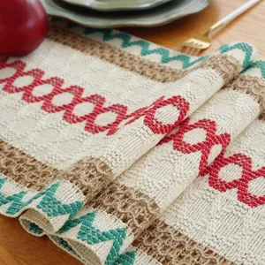 Bohemian knitted table runner with red and green geometric patterns and tassels