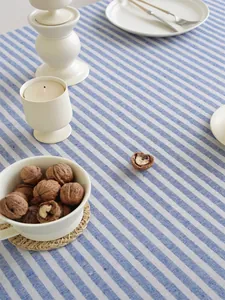 Detail van het blauw-wit gestreepte linnen tafelkleed met moderne tafelsetting