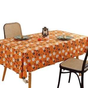 Halloween tablecloth featuring spooky pumpkins and ghosts on vibrant orange fabric background