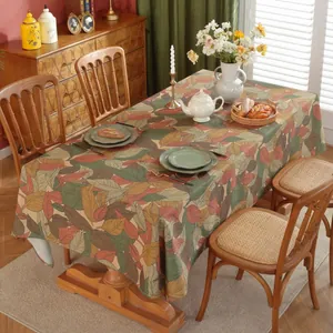 Macro detail of rectangle tablecloth with warm autumn maple leaf print on thick fabric