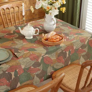 Detailed macro view of vintage autumn maple leaf print on heavy linen tablecloth fabric