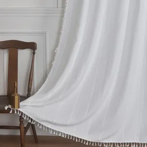 Detail of white striped polyester curtain featuring elegant chain embroidery and tassels