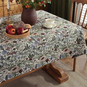Detail of jacquard floral tablecloth fabric with vintage green botanical flower patterns