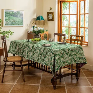 Detailed texture of thick jacquard tablecloth with vintage green floral daisy patterns
