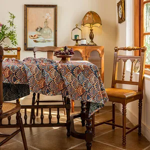Close-up of Bohemian jacquard tablecloth featuring orange and blue scalloped texture