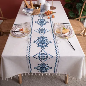 Detail of blue classic totem print and fringe edges on linen rectangular tablecloth
