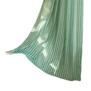 Green and white striped window curtains with gold thread details and fringe finish