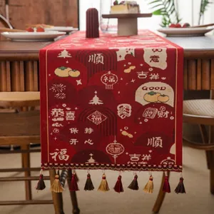 Close-up of red festive table runner with jacquard patterns, tassels and Chinese motifs