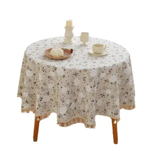 Linen cotton round tablecloth with beige floral prints and decorative fringe tassels