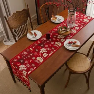 Detail of red festive table runner featuring Chinese characters and elegant tassels
