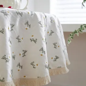 Round linen tablecloth with daisy embroidery and elegant tassels for farmhouse home decor