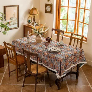 Detail of bohemian jacquard tablecloth with geometric patterns and white woven fringes