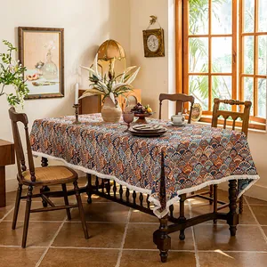 Detailed view of rectangle tablecloth with blue orange fan pattern and white tassels