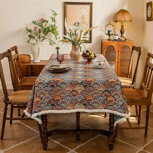 Detail of bohemian jacquard tablecloth with blue orange fan pattern and white tassels