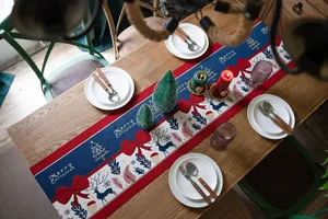 Detailed jacquard weave featuring reindeer, bows, and festive patterns on a table runner