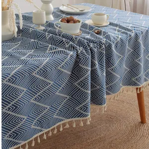 Blue and white geometric rhombus tablecloth with tassels in a minimalist boho style