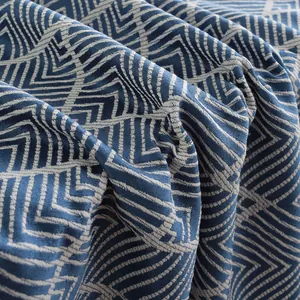 Macro shot of navy blue and white geometric wave pattern texture on jacquard tablecloth
