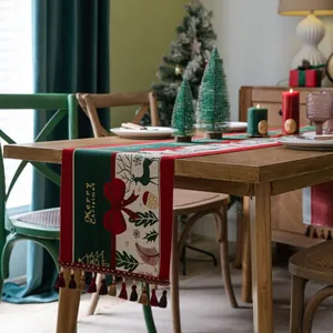 Christmas table runner with reindeer motifs, Merry Christmas text and colorful tassels