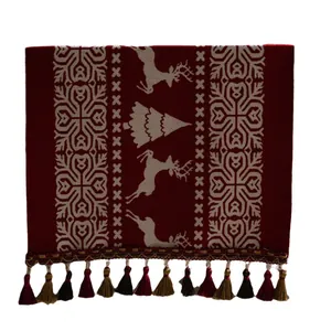 Red Christmas table runner with reindeer jacquard pattern and colorful tassels